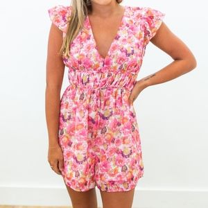 Pink Floral Tie Back RomperSleeveless with ruffle detailingV-neck
